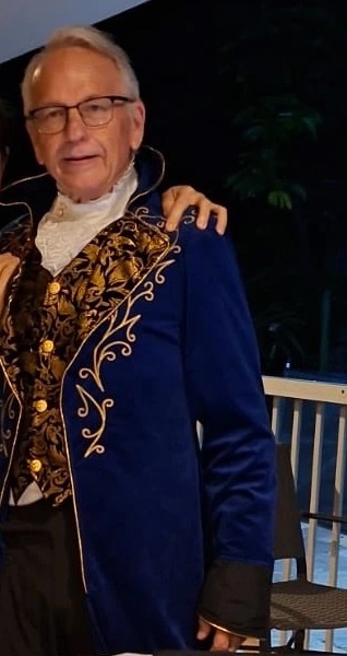 Ziggy smiling in his royal blue show coat with gold embroidery after a show